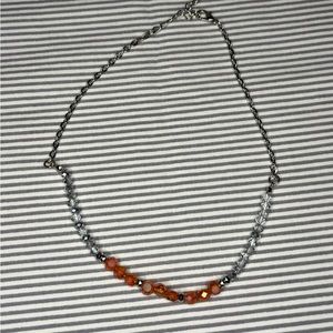 silver necklace with pink and clear center beads